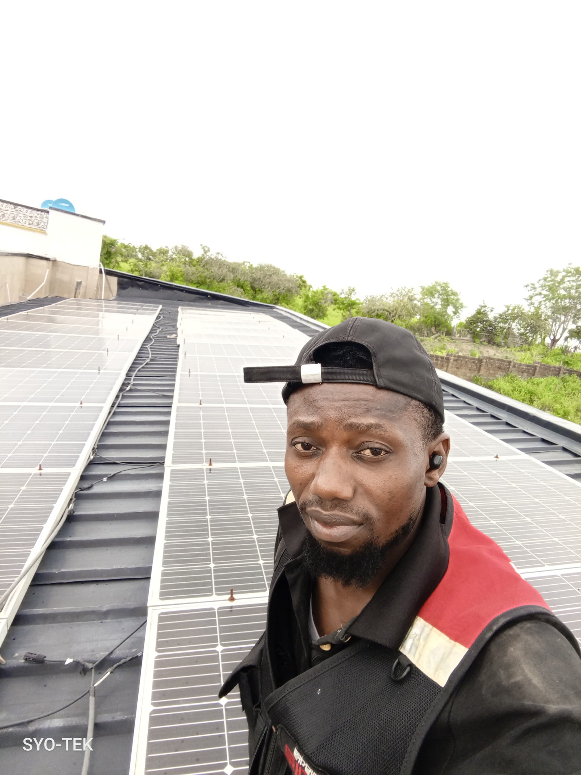 SYO TEK technician on a rooftop solar panel installation